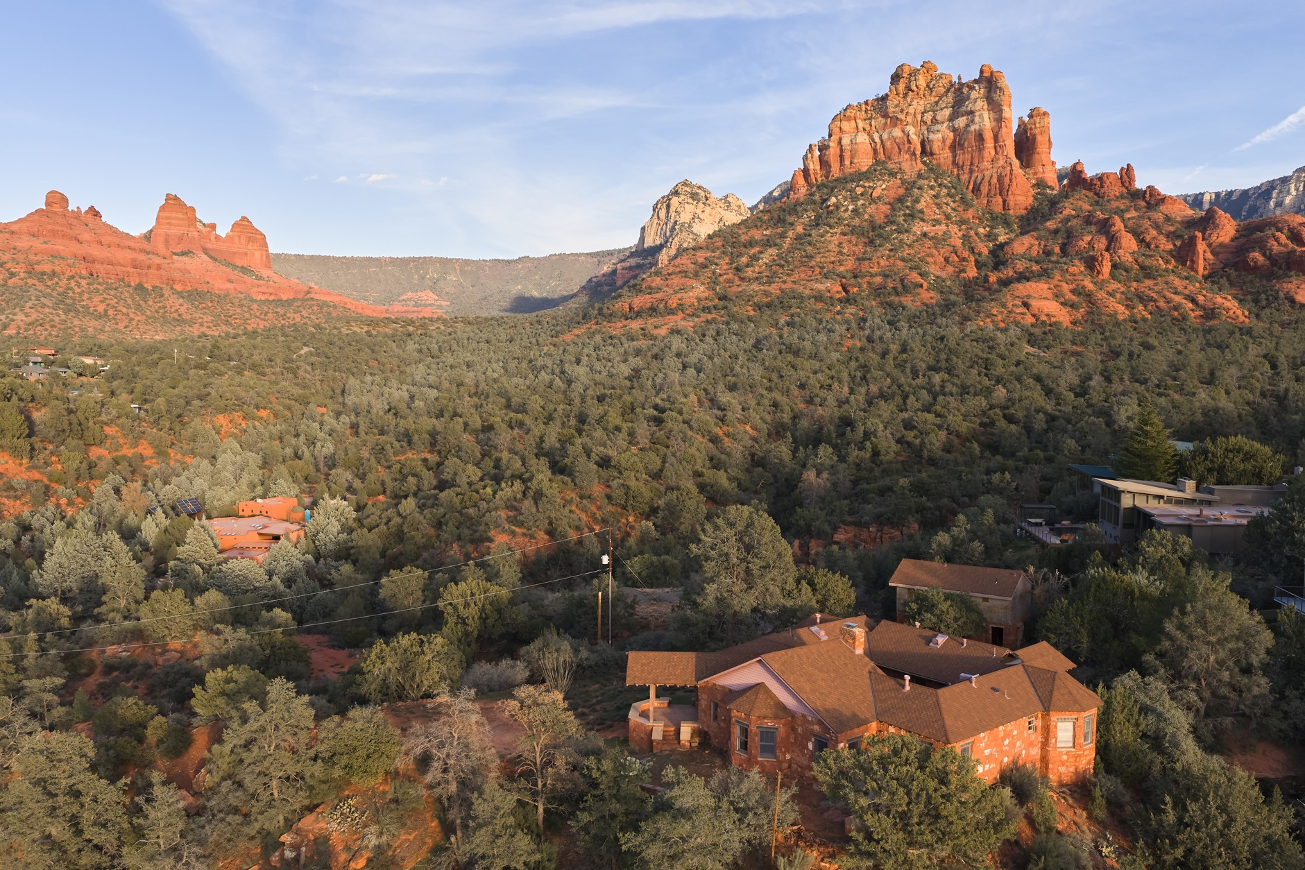 Aerial of estate surrounded by red rock formations
